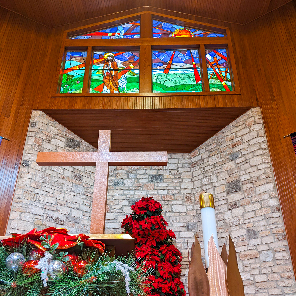 Cross and red poinsettias with stained glass
