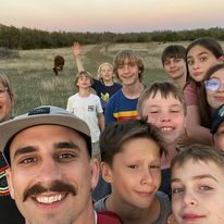 youth leader and kids at beach retreat